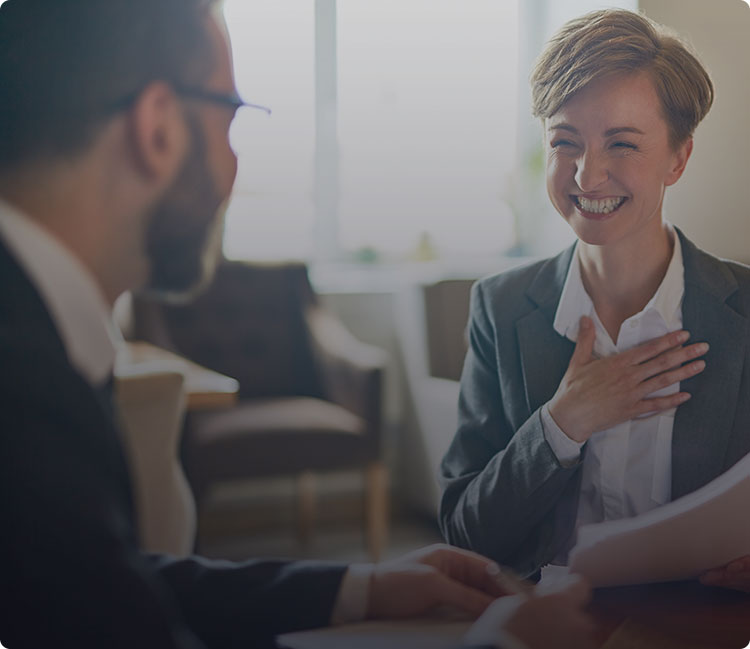 a man and woman in business attire are talking