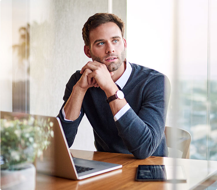 a man sitting at a desk with his laptop